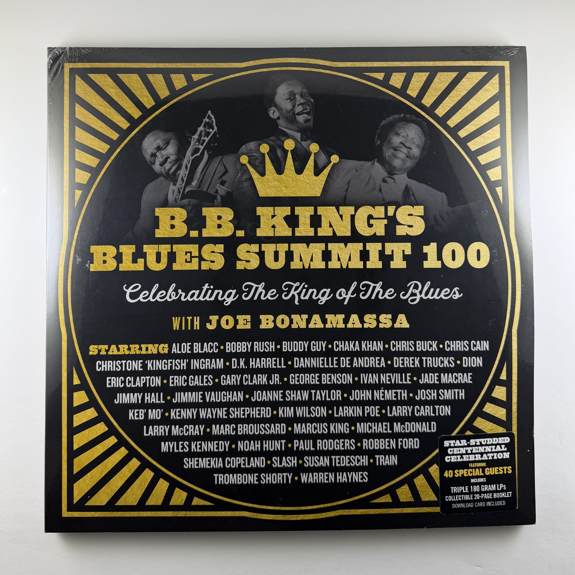 Album cover for B.B. King's Blues Summit 100 featuring a crown and images of musicians on a black and gold design.