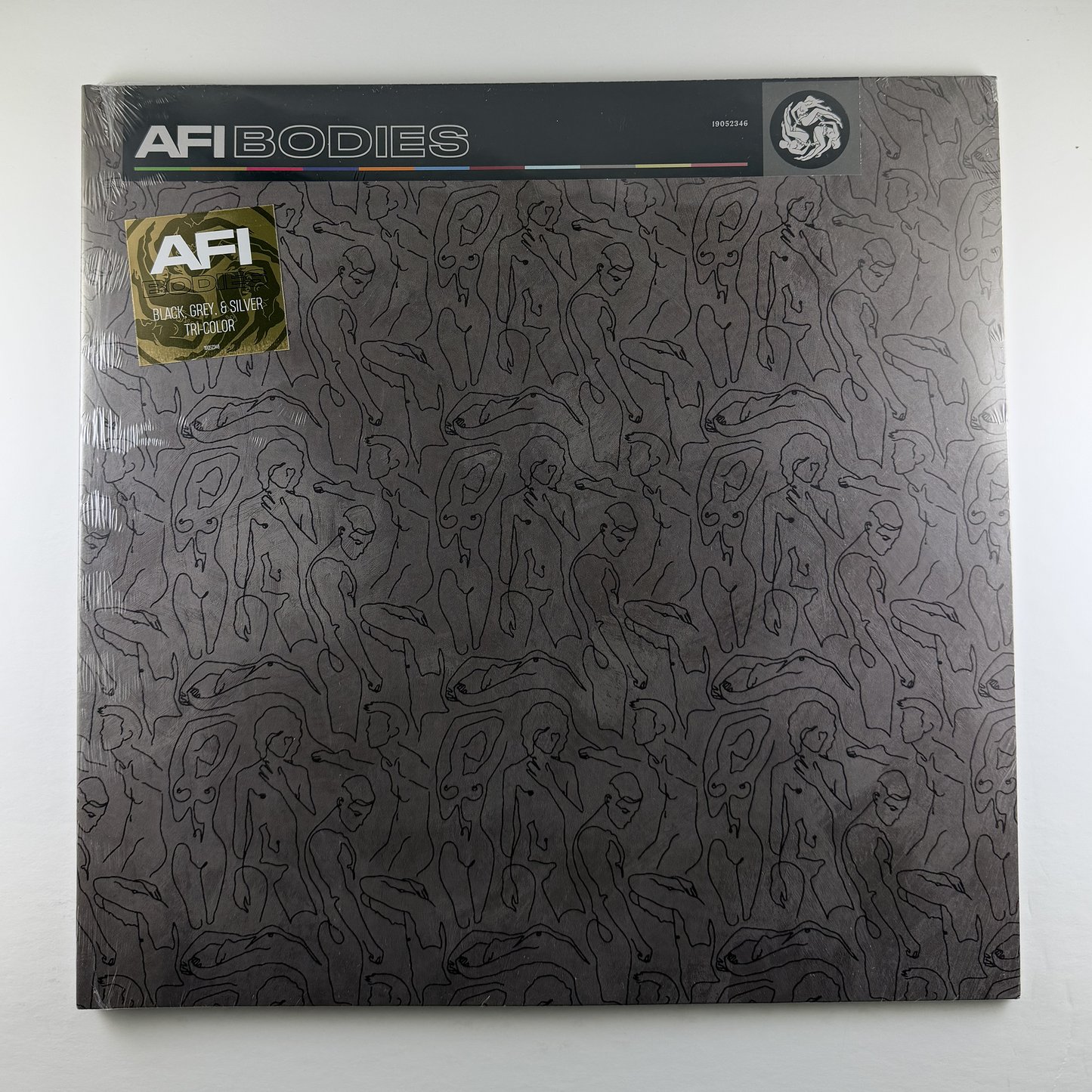 Vinyl record cover with AFI branding and abstract design on a dark background.
