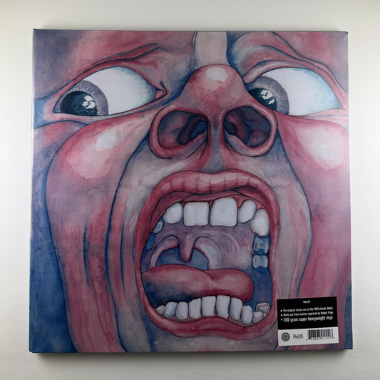 Vinyl record cover with a stylized face design